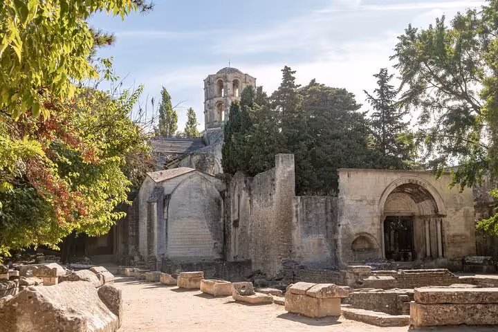 Ancient Roman ruins and medieval church tower at Alyscamps necropolis in Arles, France