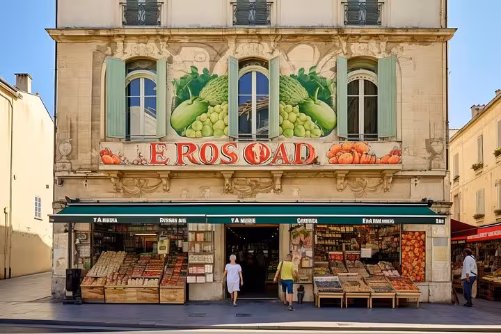 Charming storefront in Arles with colorful produce and decorative murals, an inviting stop on a guided walking tour.
