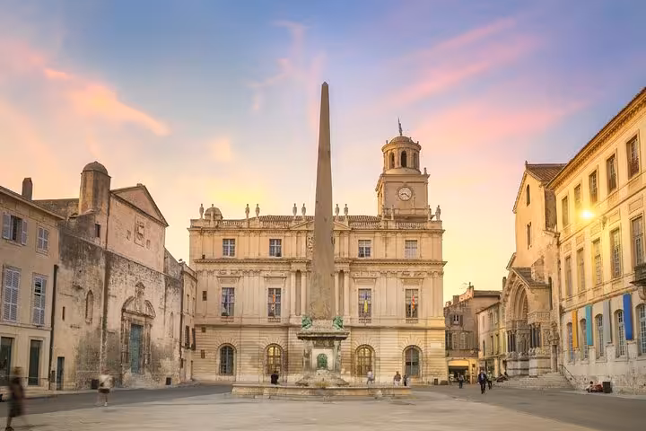 Place de la République in Arles with obelisk fountain and historic Town Hall at sunset