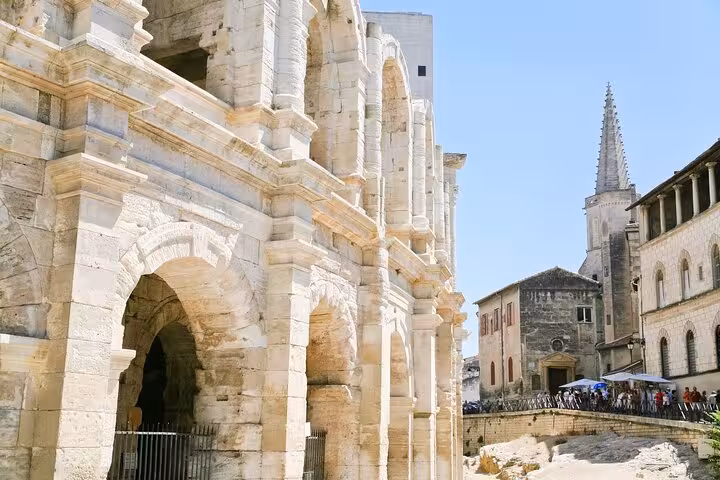 Explore Arles' ancient Roman amphitheater and historic architecture on a private 2-hour city walk with a local guide.