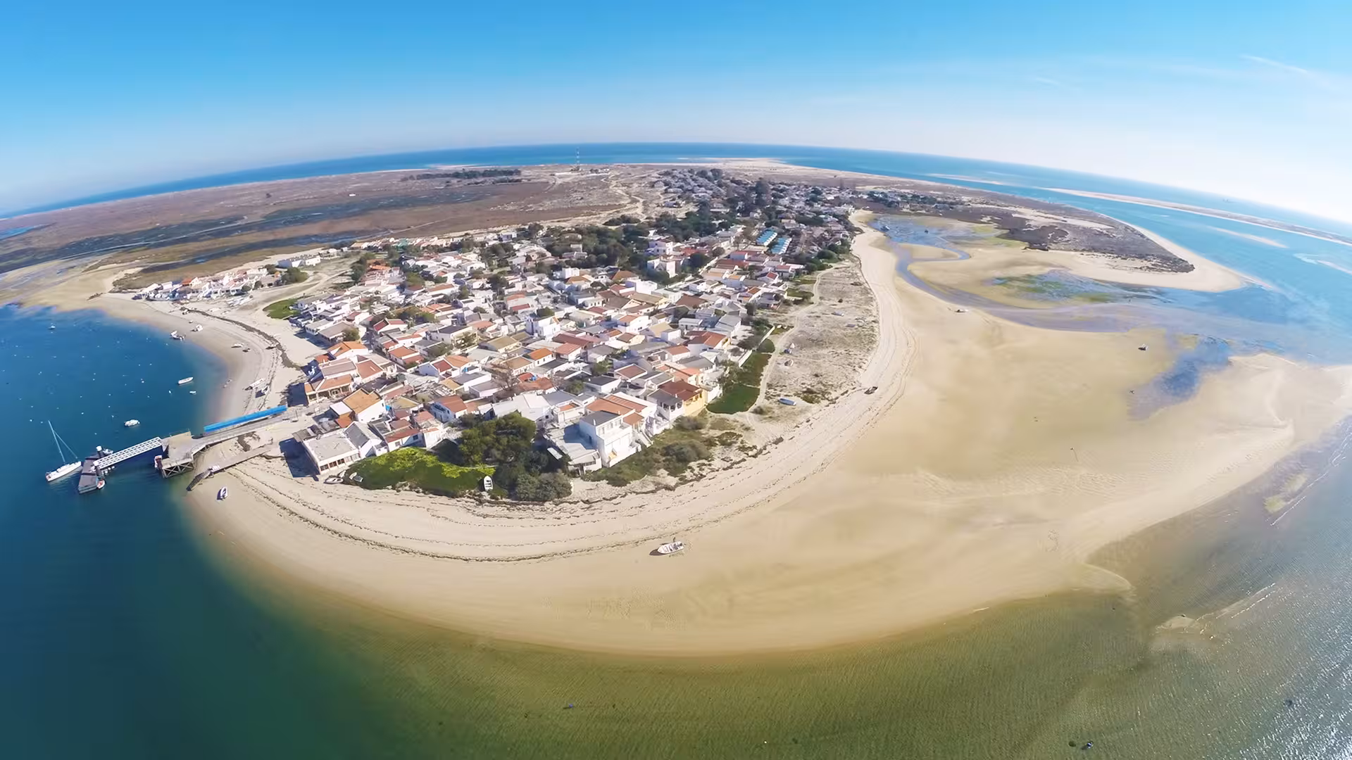Panoramic aerial view of Armona Island sandy shores and white houses in Ria Formosa Natural Park Olhao boat tour