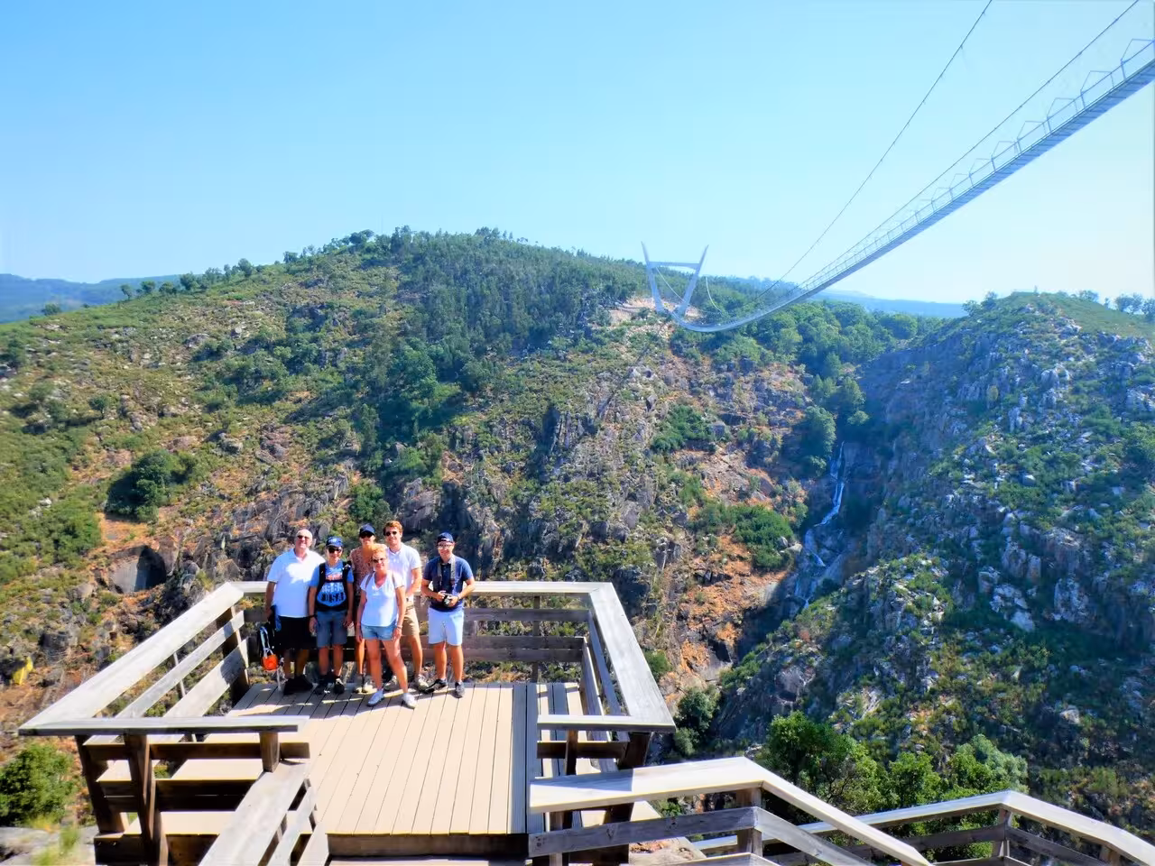 Tour group at Arouca viewpoint with 516 Arouca suspension bridge over Paiva Gorge on day trip from Porto