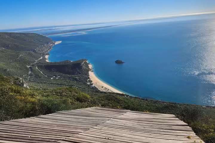 Stunning coastal view from Arrábida on a clear day, showcasing the pristine beaches and azure waters on the tour.