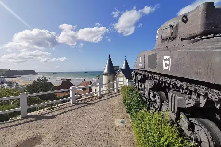 Arromanches-les-Bains viewpoint with WWII tank above Gold Beach on Normandy private day tour from Paris