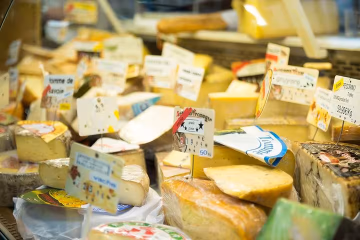 Variety of artisanal cheeses displayed at a market near the Marais, inviting exploration on the local walking tour.