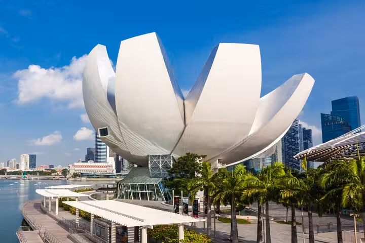 The ArtScience Museum in Singapore, resembling a lotus flower, stands prominently against the Marina Bay skyline.