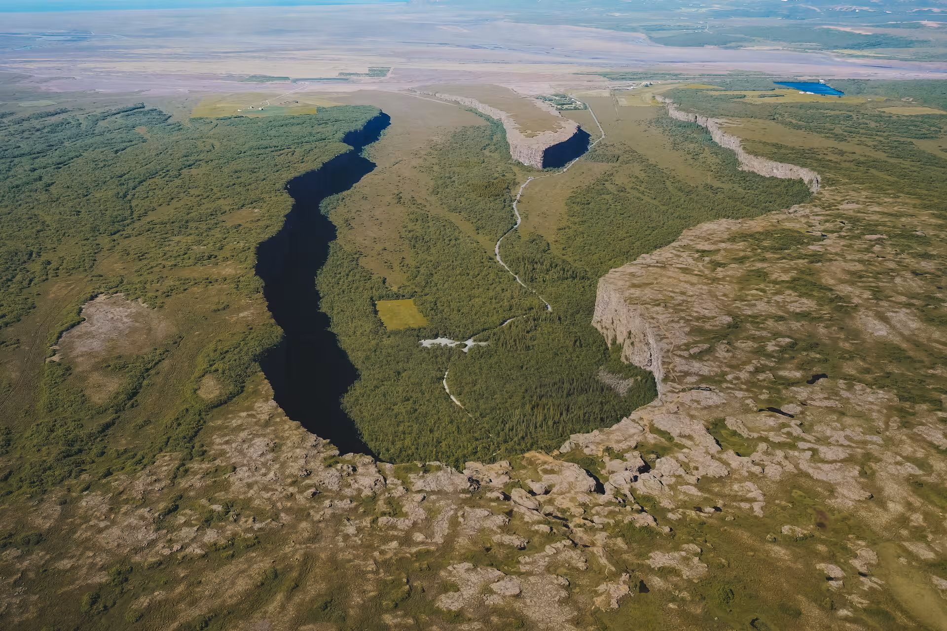 Aerial view of Ásbyrgi Canyon horseshoe cliffs and forest, highlight of Iceland Adventure Diamond Circle Tour