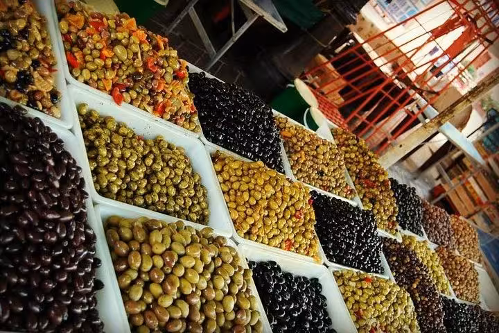 Close-up of assorted olives at a market in Nice, showcasing local culinary delights on a food tour.