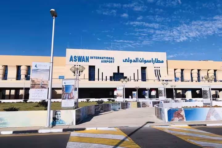 Aswan International Airport daytime exterior and arrivals area, meeting point for private airport transfer to Aswan hotels