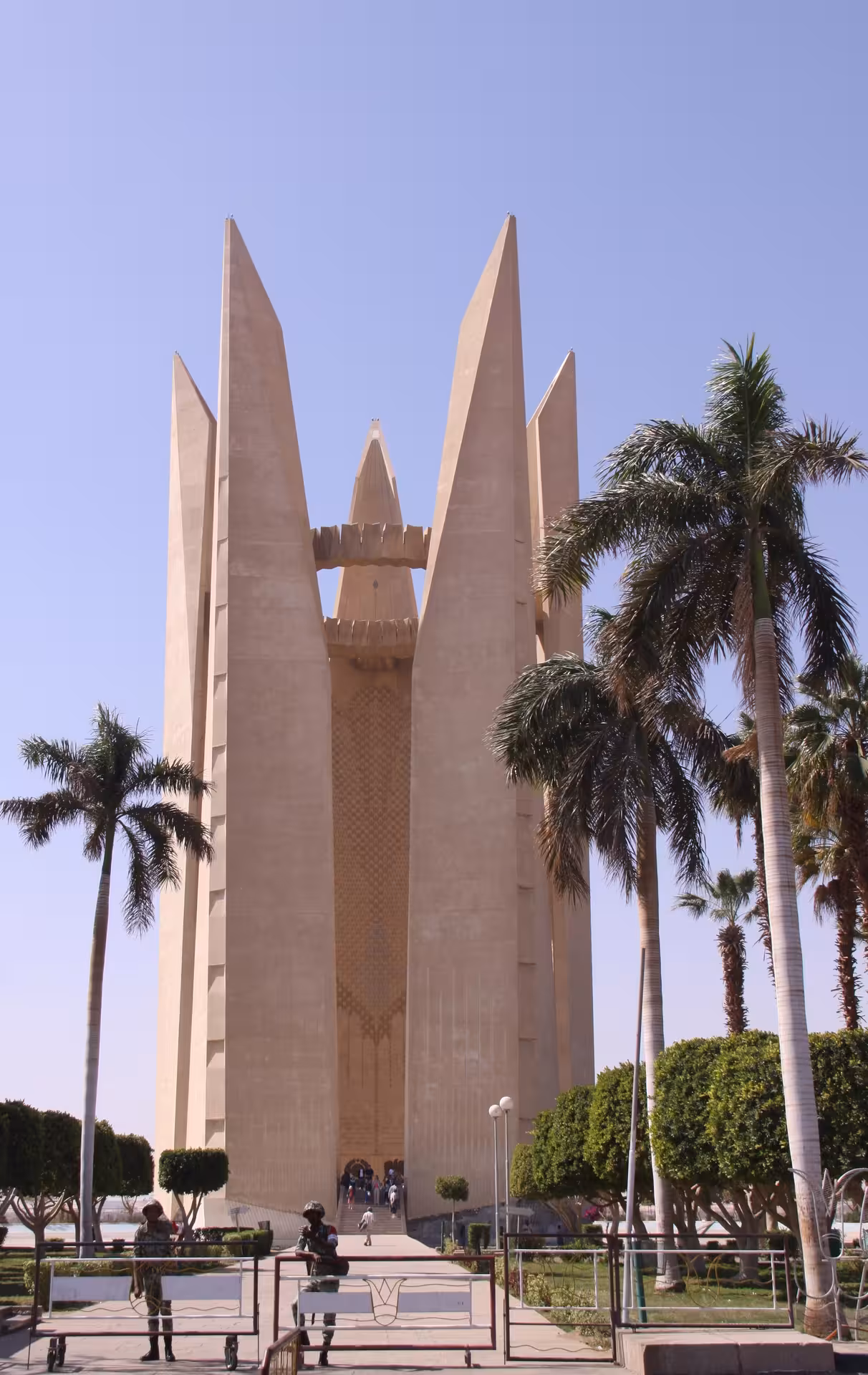 Soviet-Egyptian Friendship Monument at Aswan High Dam with palm trees and clear blue sky