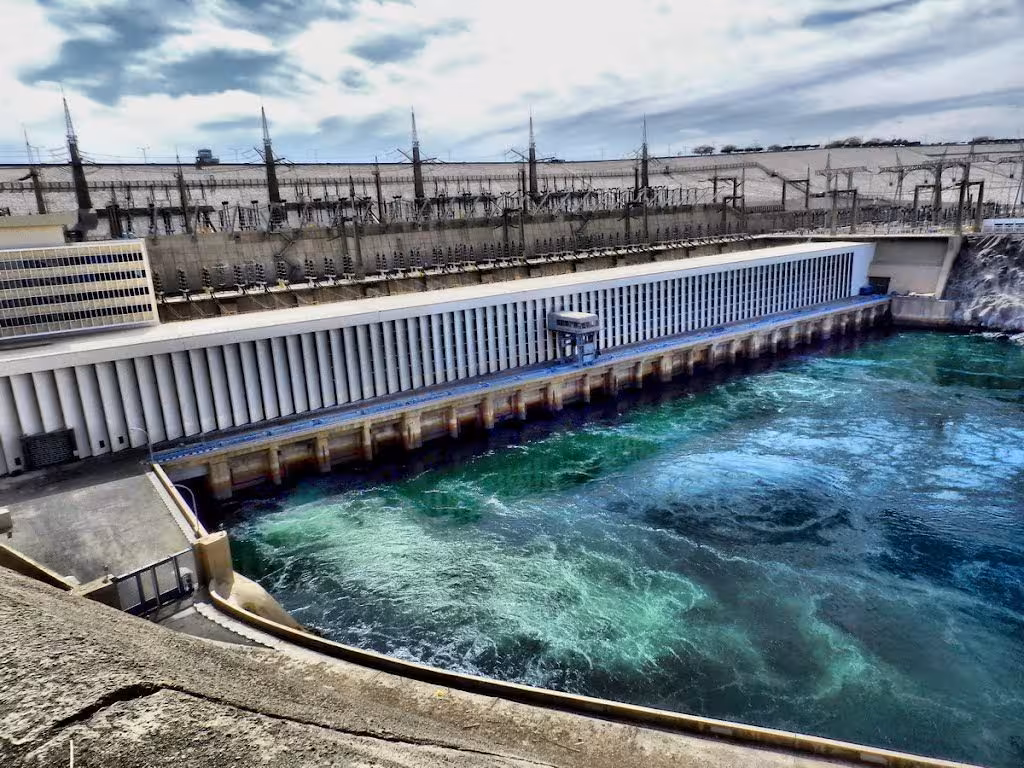 Aswan High Dam on the Nile with swirling blue water, scenic stop on 3-day private Luxor to Aswan tour