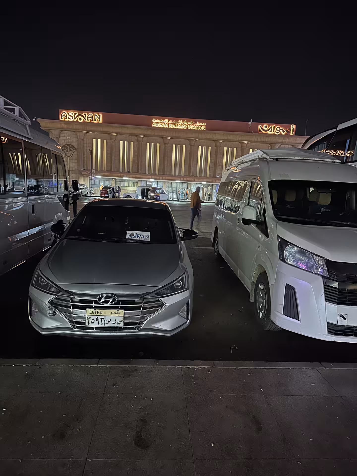 Aswan Railway Station at night with tour vehicles, pickup point for early morning Abu Simbel trip with transport