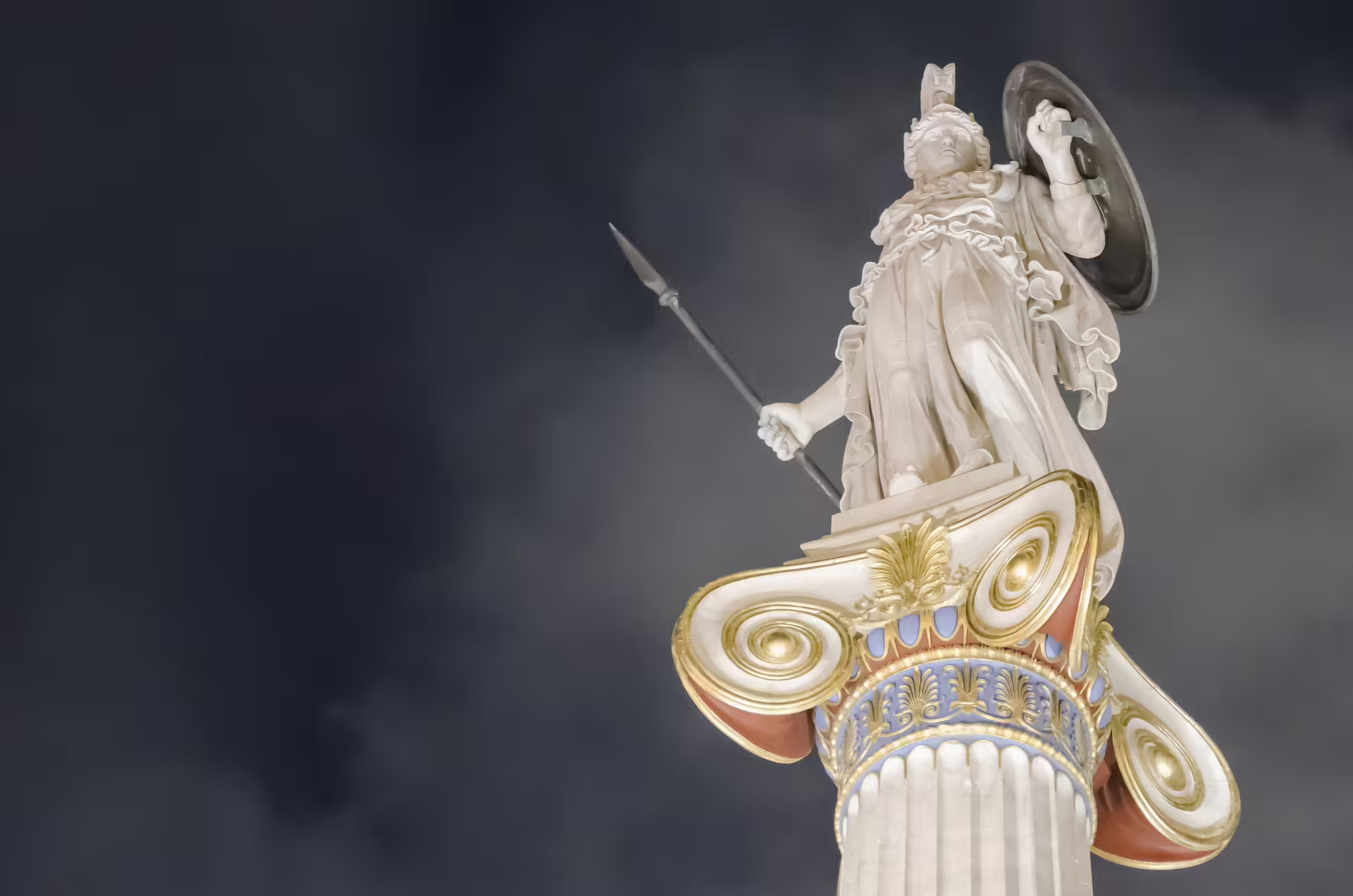 Athena statue atop a neoclassical column in Athens, cultural landmark on private panorama and Cape Sounio tour