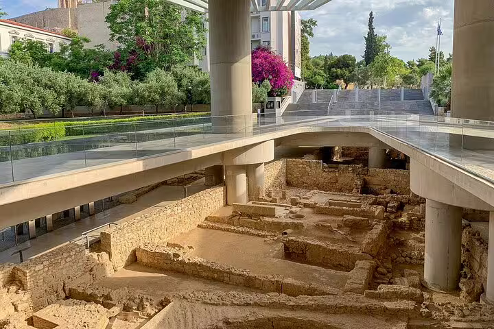 Ancient ruins beneath glass walkway at Athens Acropolis Museum, highlight of a classical full day private tour