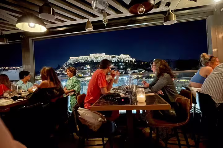 Rooftop dinner with illuminated Acropolis view, ideal stop on Athens half-day private tour city highlights