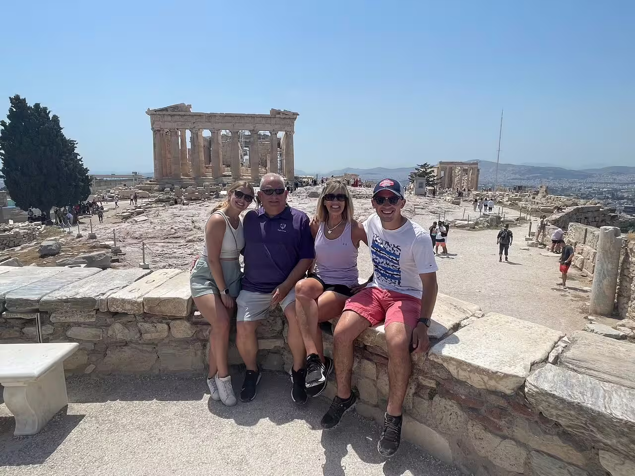 Small group at the Acropolis in Athens with Erechtheion ruins behind, on a guided sightseeing tour with entry tickets