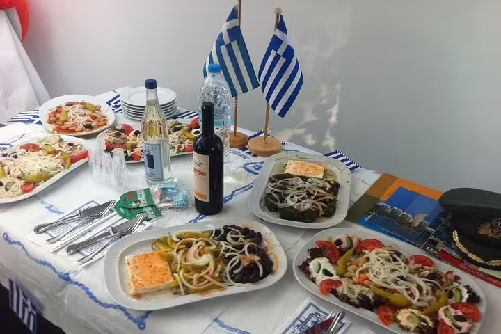 Greek meze spread with wine and flags, authentic lunch during Athens half-day private Acropolis and city tour