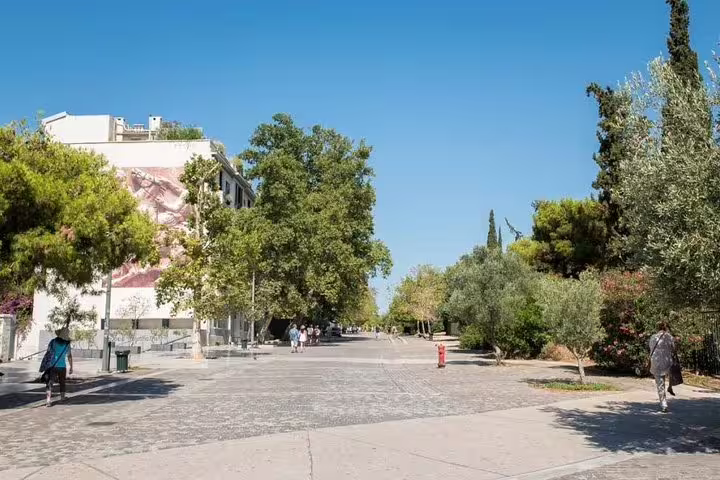 Stroll through a leafy Athens promenade on an afternoon city tour before a traditional Greek dinner experience