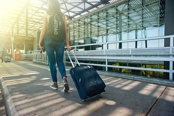 Traveler with suitcase outside Athens Airport, meeting driver for private arrival transfer to Lavrio Port