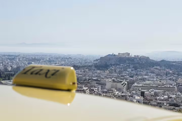 Athens taxi sign overlooking city skyline for Athens Airport to Lavrio Port private transfer service