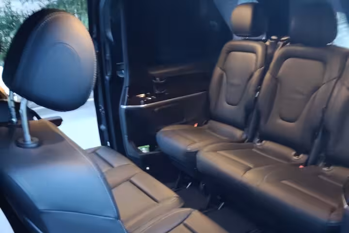 Executive black leather seating in private luxury transfer van from Athens Airport to Piraeus Port hotels