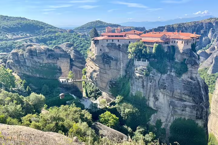 Meteora cliff-top monastery view on Greece day trip, ideal add-on after Athens airport to Piraeus transfer