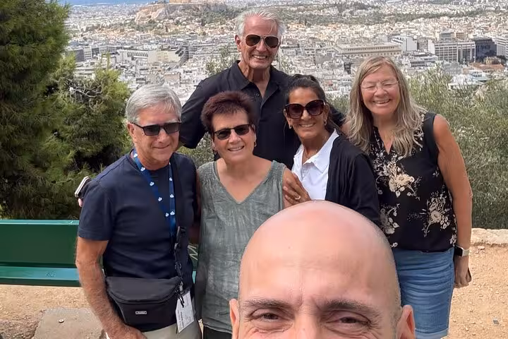 Travelers enjoying Athens viewpoint during airport transfer with express city highlights private city tour