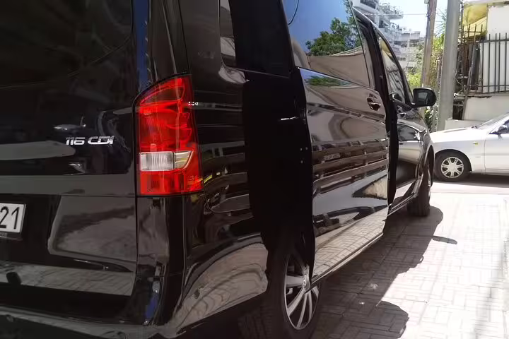Black minivan with sliding door open for Athens Airport transfer to Hilton, Novotel, Crowne Plaza and Marriott