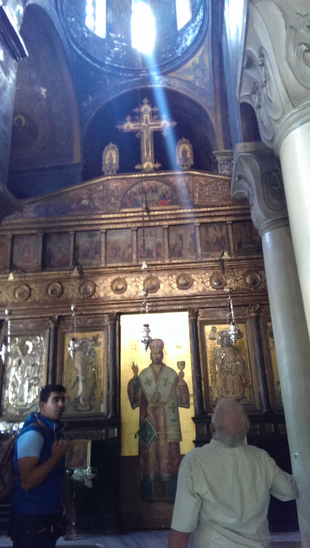 Inside an Athens Byzantine church with iconostasis and sunbeam, visited on Plaka Monastiraki walking tour