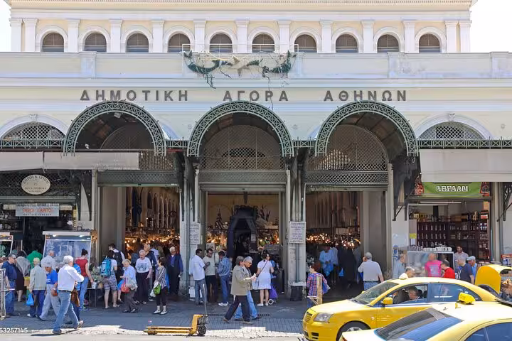 Bustling Athens Central Market entrance with crowds exploring vibrant Greek food stalls on a culinary tour.