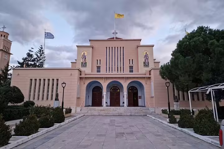 Athens to Corinth private Apostle Paul tour stop at a Greek Orthodox church facade with flags
