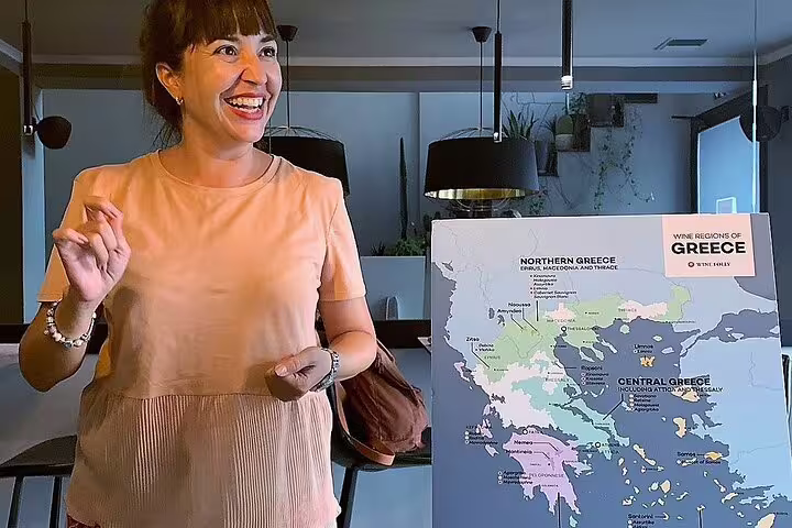 Local guide explains Greek regions map during Athens gourmet food small group walking tour and tastings