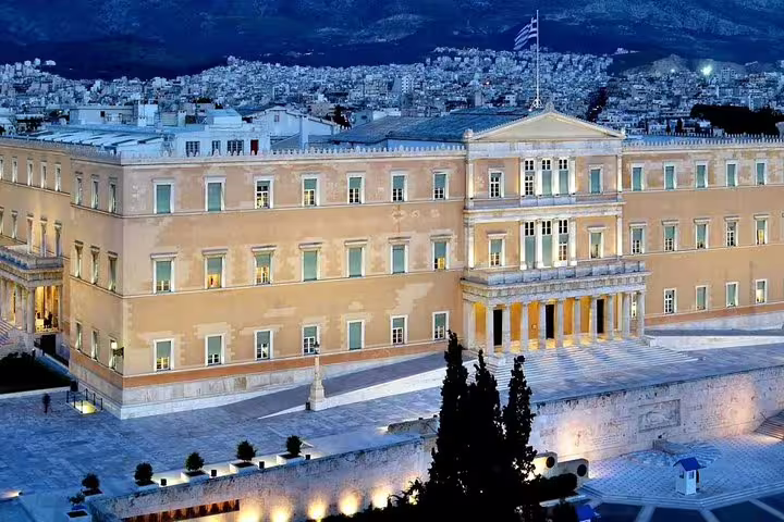 Illuminated Hellenic Parliament building at Syntagma Square, key stop on Athens Highlights private half-day tour