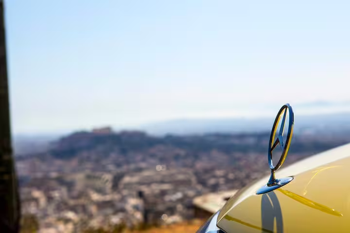 Private Athens hotel to Lavrio port transfer in luxury sedan, scenic city view before cruise departure