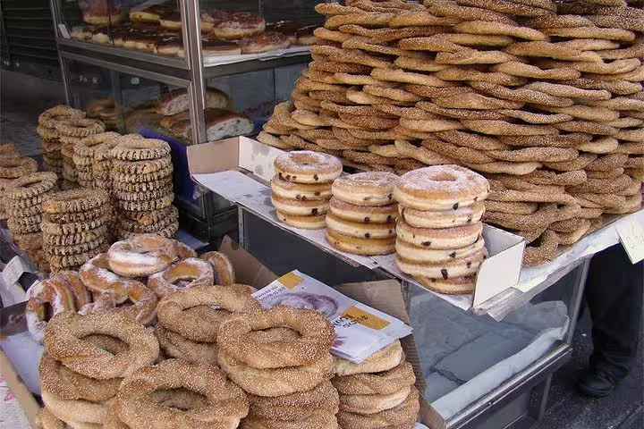 Stacks of sesame koulouri and sweet pastries at an Athens bakery stop on a small-group food tour