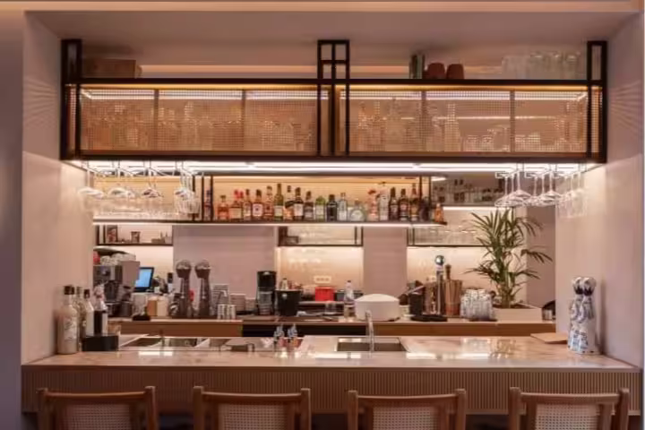 Elegant dining bar setup for ATHENS Mythology Dinner Experience, featuring rustic decor and ambient lighting in a cozy atmosphere.