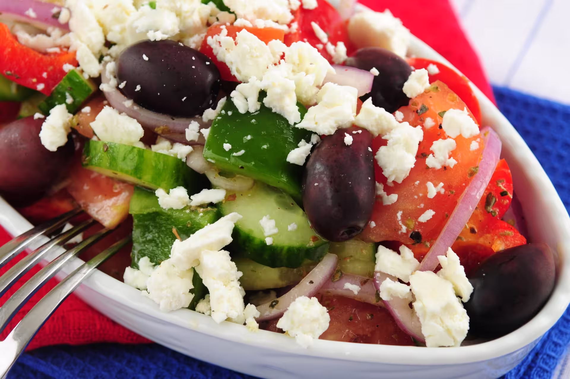 Vibrant Greek salad with feta, olives, and fresh vegetables, part of the immersive Athens Mythology Dinner Experience.