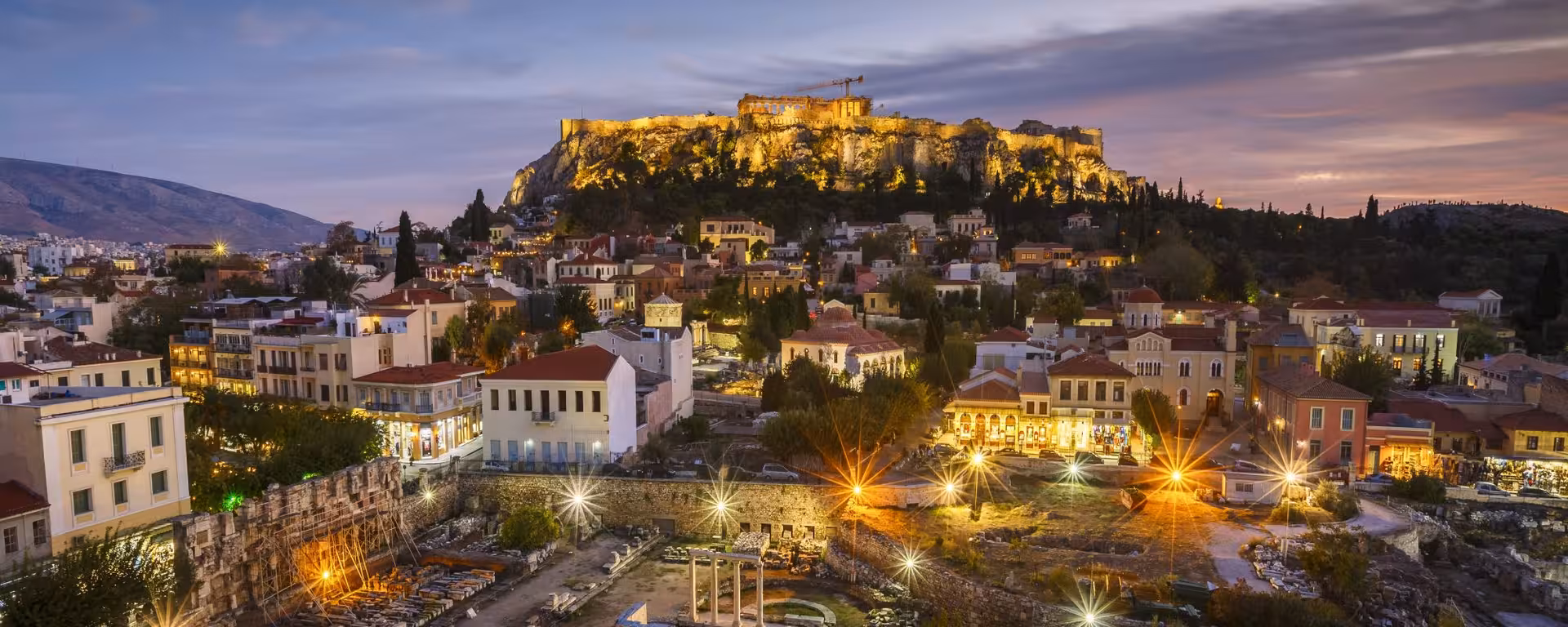 Illuminated Acropolis above Athens at dusk, perfect backdrop for a night food walk with gyros and loukoumades
