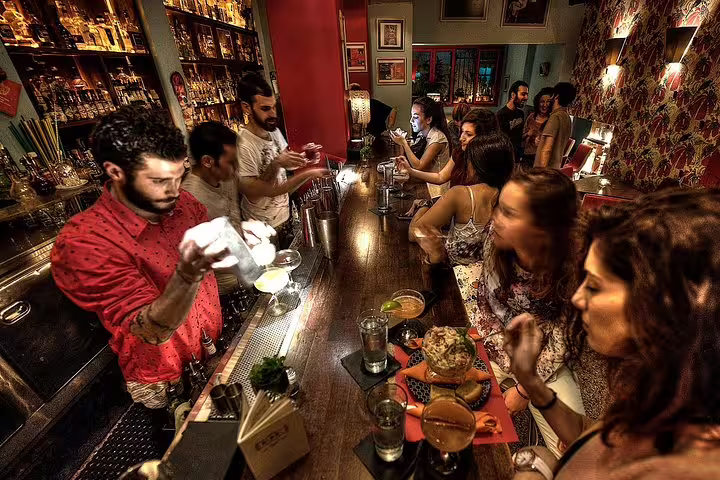 Small group Athens by night bar stop with cocktails and Greek meze tasting, lively local nightlife scene