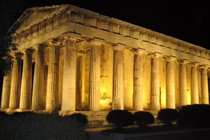 Temple of Hephaestus illuminated at night in Ancient Agora, Athens small-group evening walking tour and dinner