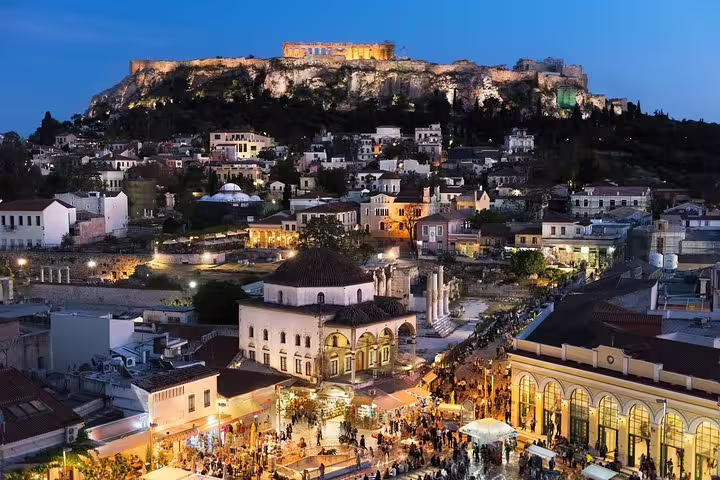 Acropolis and Monastiraki Square glowing at dusk, a must-see stop on an Athens highlights night tour