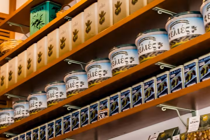 Greek olive jars and tins on shop shelves during Small Group Athens walk and taste tour for cruise travelers