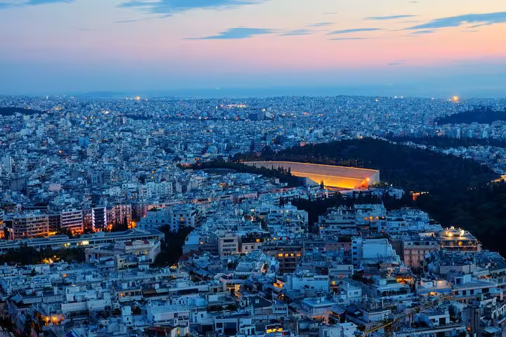 Twilight Athens skyline with glowing Panathenaic Stadium, panoramic small group tour before Plaka by night