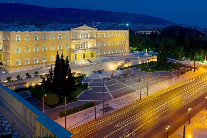 Illuminated Greek Parliament building at night in Athens, perfect for a private evening sightseeing tour with stunning city views.