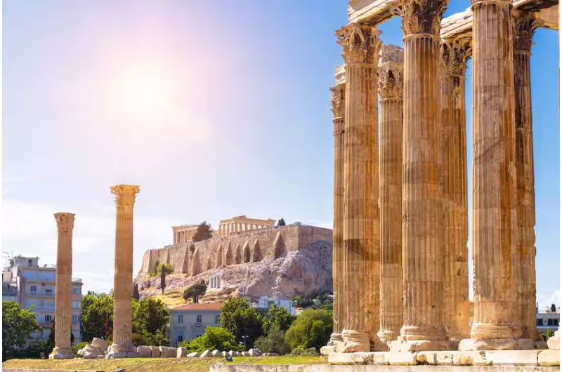 The Parthenon and Temple of Olympian Zeus bathed in sunlight, showcasing classical Athens on an e-bike excursion.