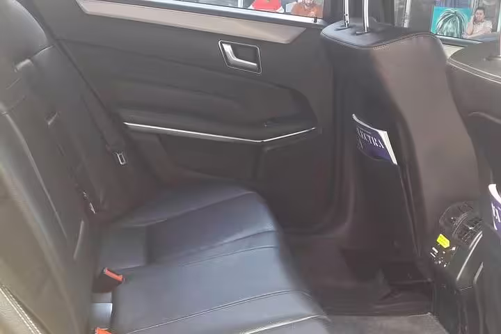 Comfortable black leather rear seats in private car transfer from Athens city centre to Piraeus port
