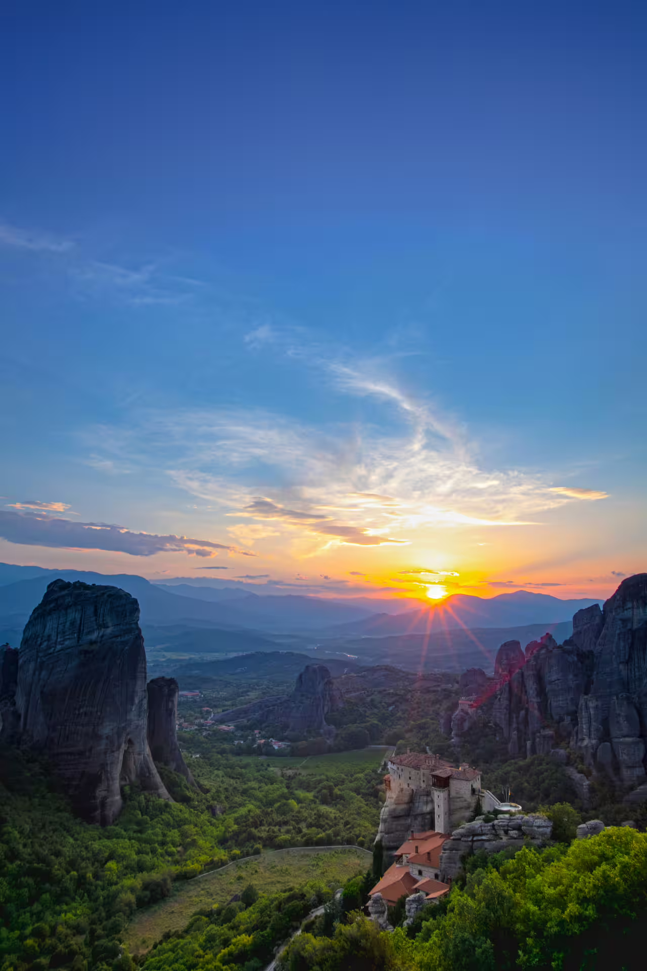 Sunset panorama of Meteora rock monasteries in Greece, scenic stop option from Athens private transfer