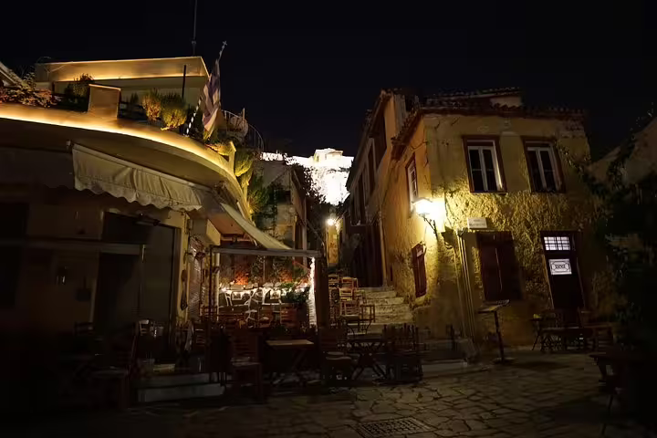 Plaka alley at night with warm lights and Acropolis views, a highlight of an Athens small-group walking tour