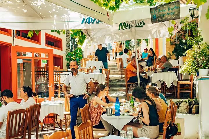 Outdoor taverna in Athens Plaka with diners enjoying Greek meze on Small Group Athens Walk and Taste