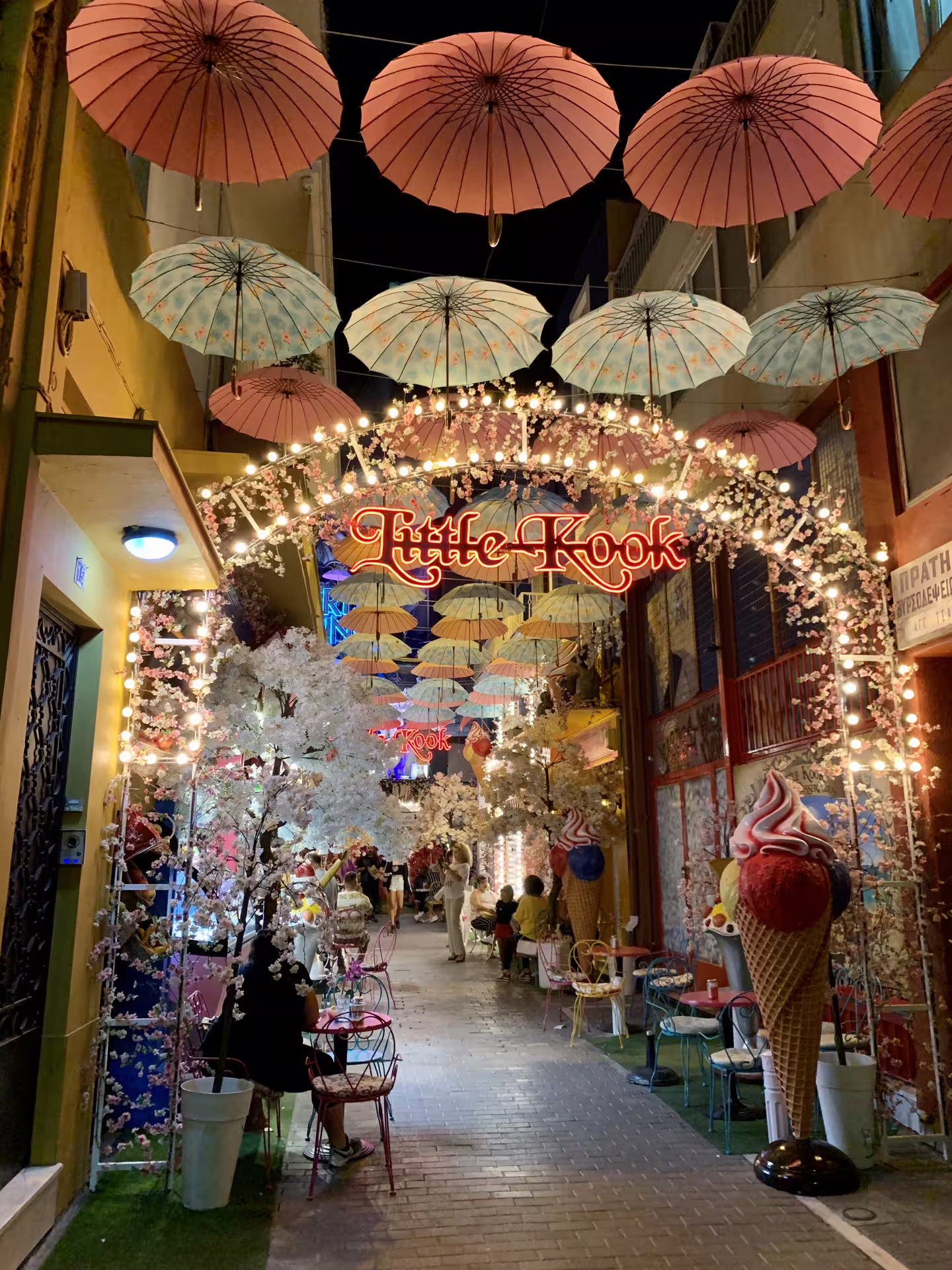 Colorful umbrella street in Athens at night, lively Plaka lane on private panorama tour before Cape Sounio